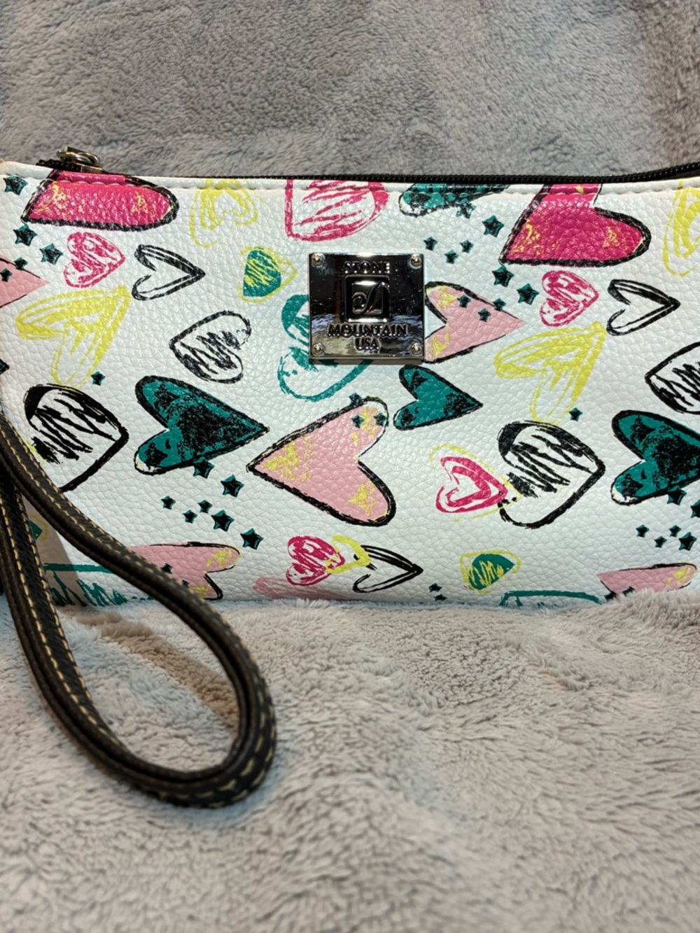 Stone Mountain brand wristlet purse featuring a vibrant heart pattern